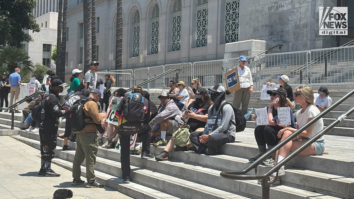 Protesters gather on the steps of Los Angeles City Hall