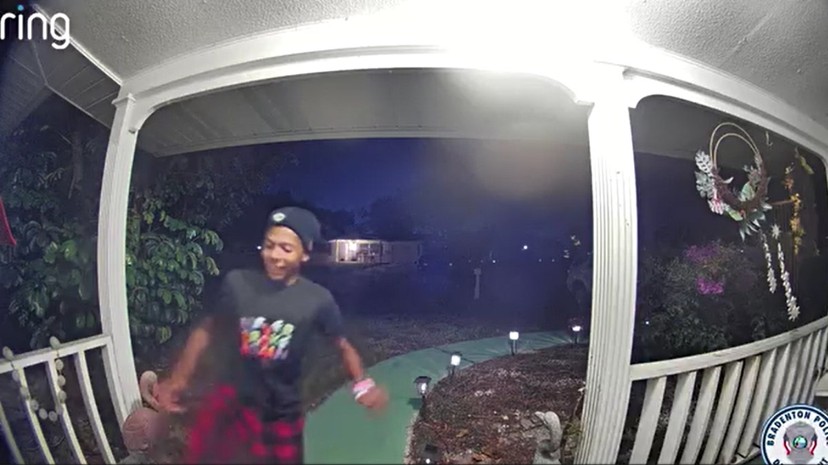 A person kicks in a door on security camera footage