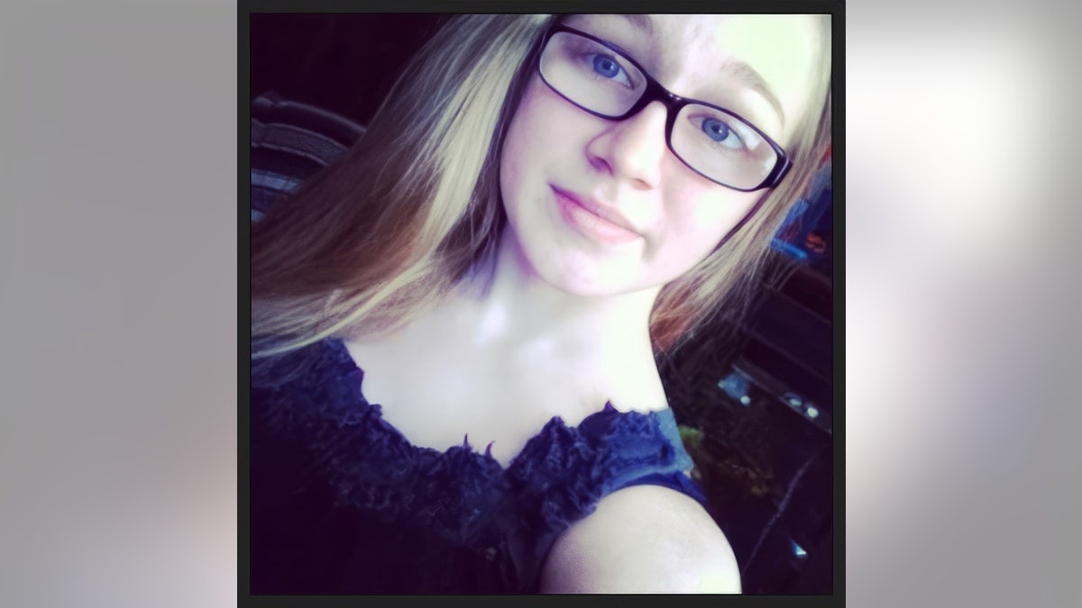 Emily Ferlazzo's proximity by taking a selfie wearing a dark blue dress.