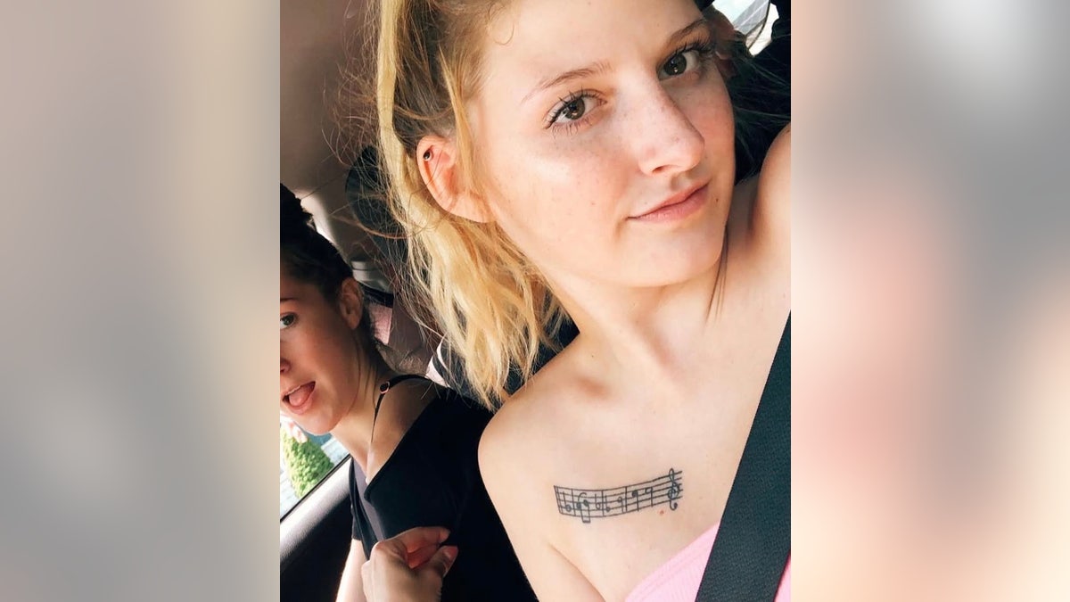 A close-up of Emily Ferlazzo showing off her music tattoo