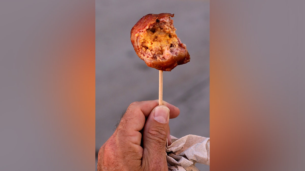 Person holding bacon ball
