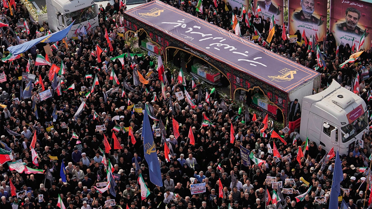 Iran holds funeral for scientists, commanders killed in war