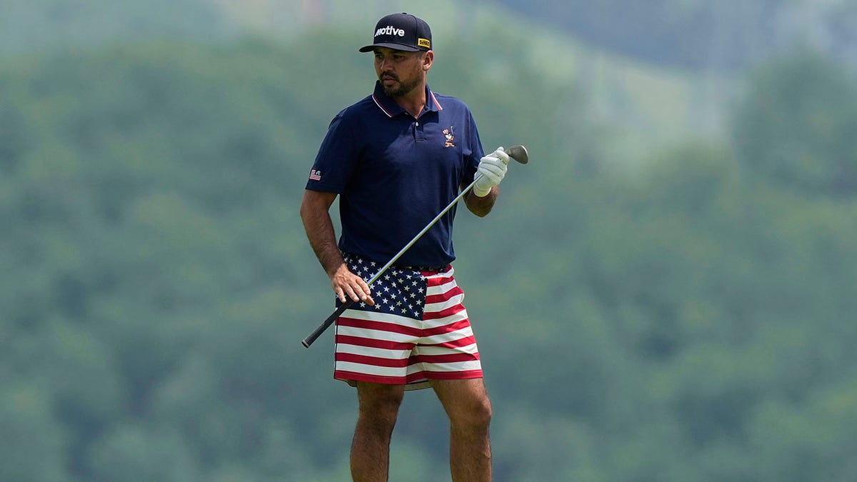 Jason Day looks on course