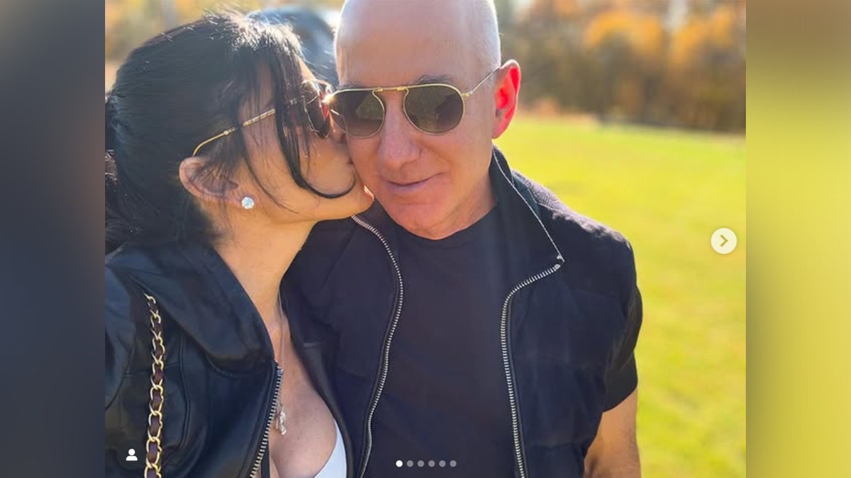 Lauren Sanchez kissing Jeff Bezos on the cheek.