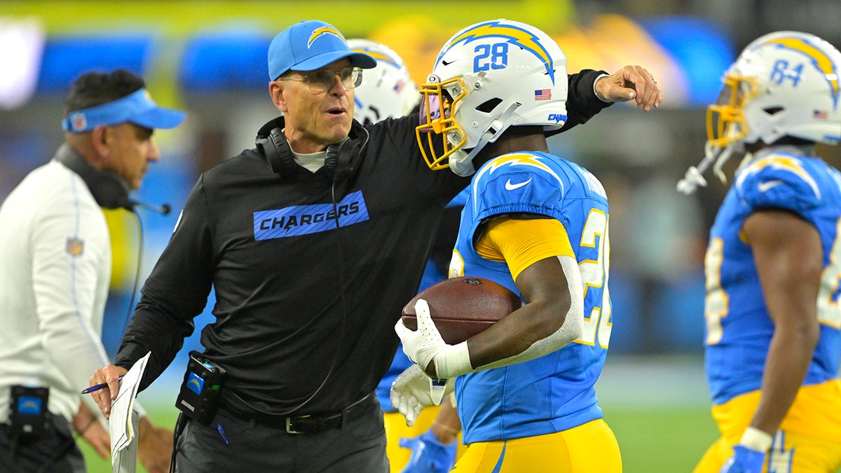 Jim Harbaugh congratulates Hassan Haskins