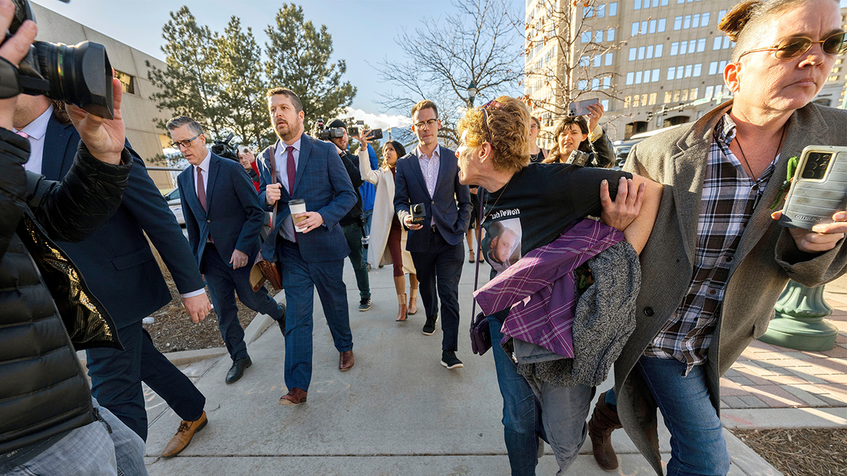 Christina page, All right, Heather De Wolf stays while shouting in Jon Hallford, left, owner back to the funeral of nature