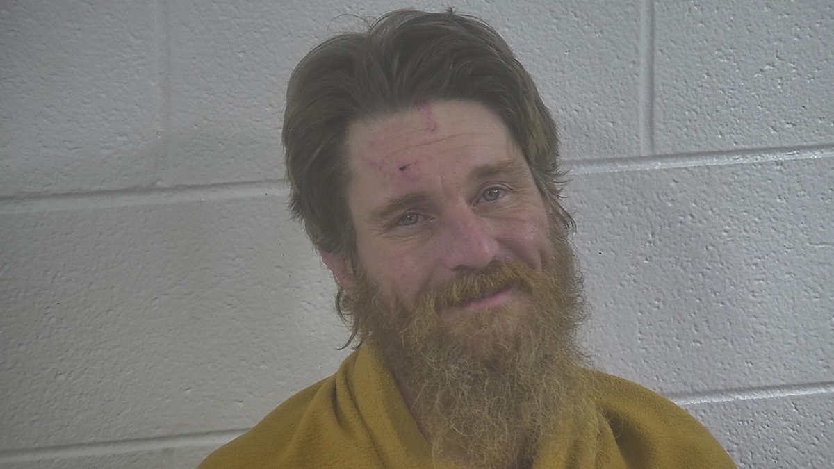 Jonathan Mason smiling in his mugshot