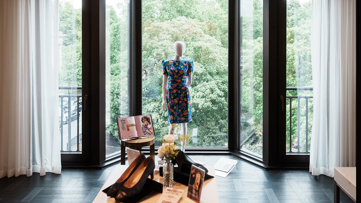 Princess Diana's items on display with trees facing a window.