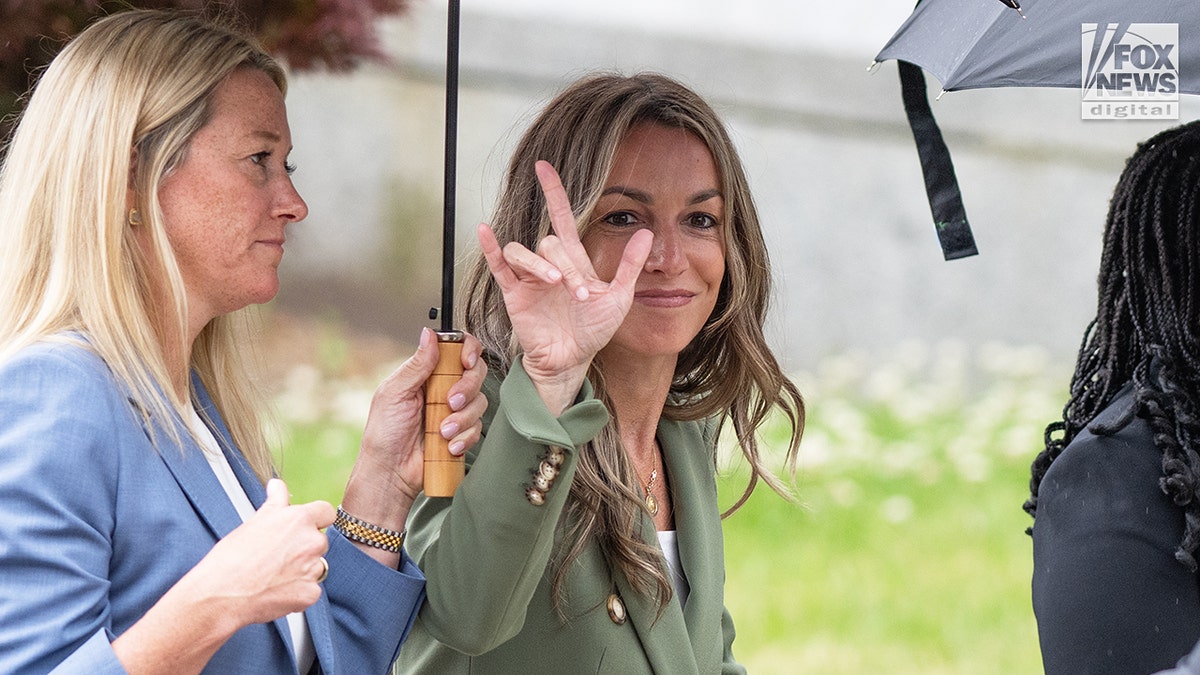 Karen Read signs to fans as she exits court
