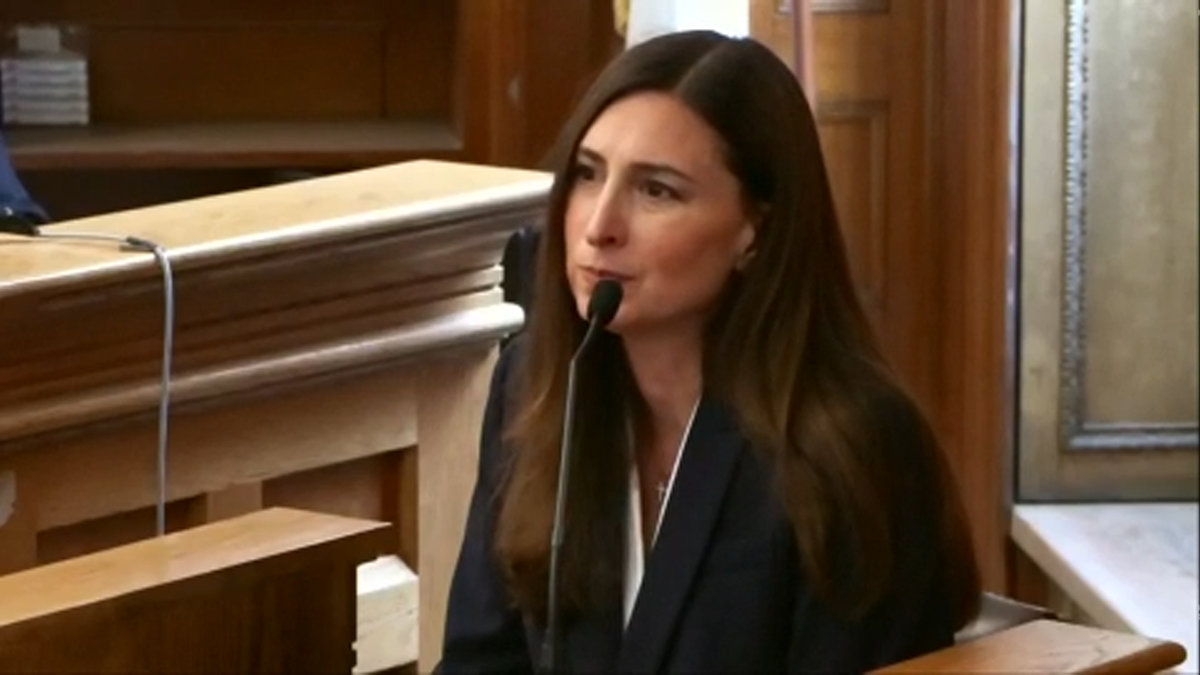 karina kolokithas wearing black blazer over white blouse, sitting in a witness stand during karen read trial