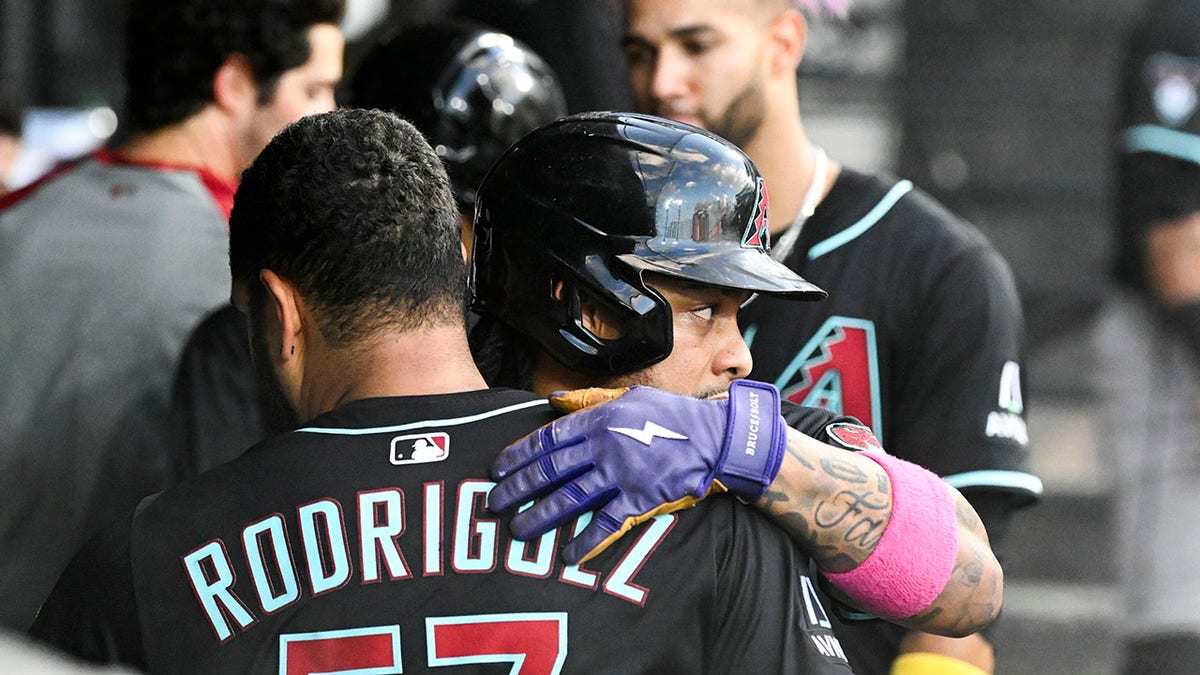 Ketel Marte hugs Eduardo Rodriguez