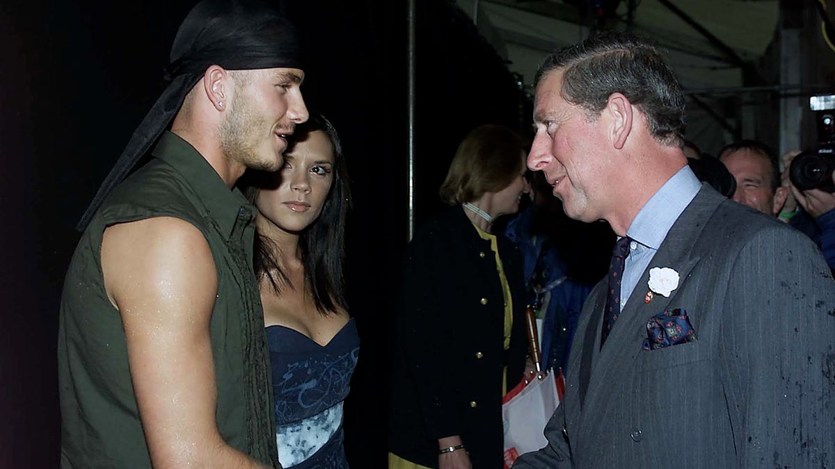 A young David and Victoria Beckham meeting the former Prince Charles.