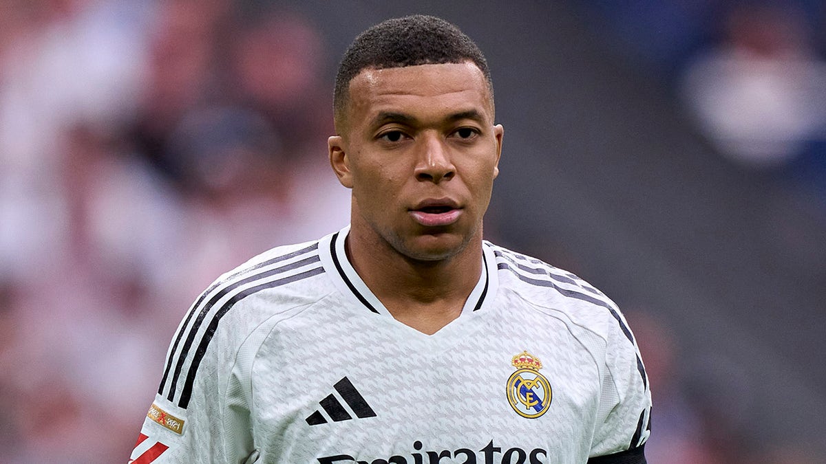 Kylian Mbappe looks on pitch