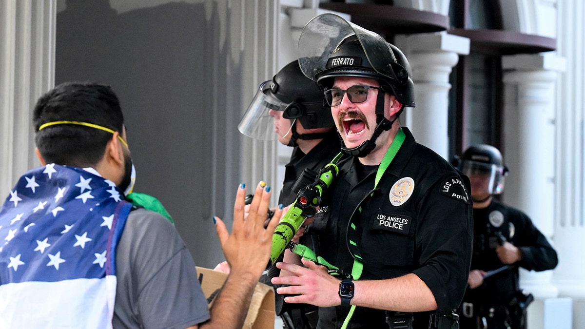 LAPD officials seem to be screaming at Rioter