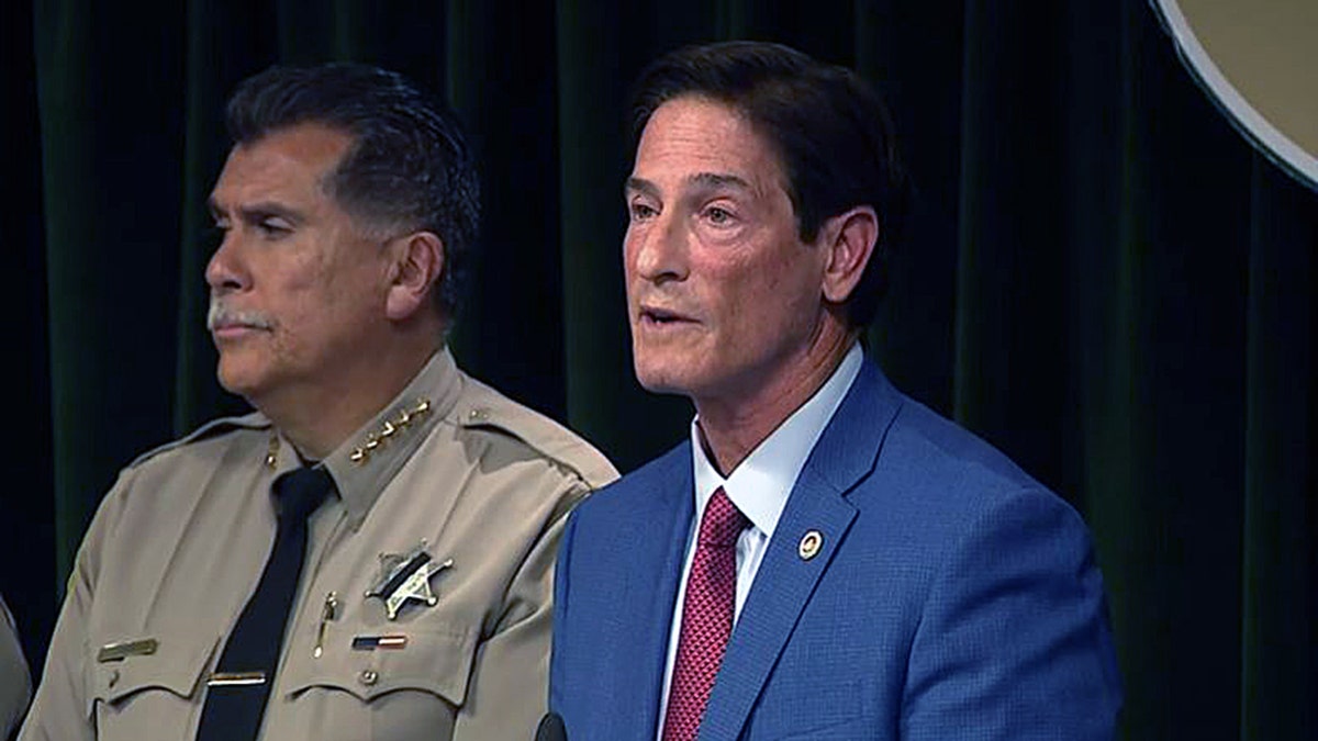 Nathan Hochman speaks at a press conference as Sheriff Robert Luna listens beside him