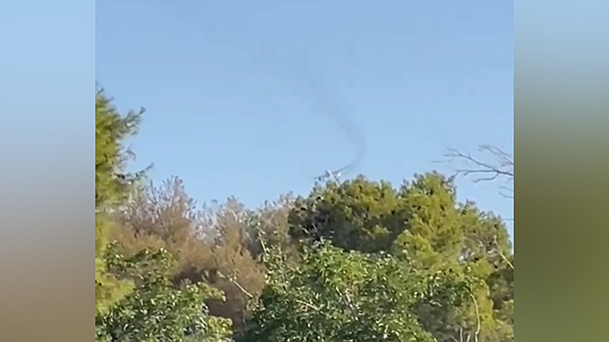Dark fume billowed from an airplane arsenic it passed by the Las Vegas National Golf Course connected June 25, 2025.