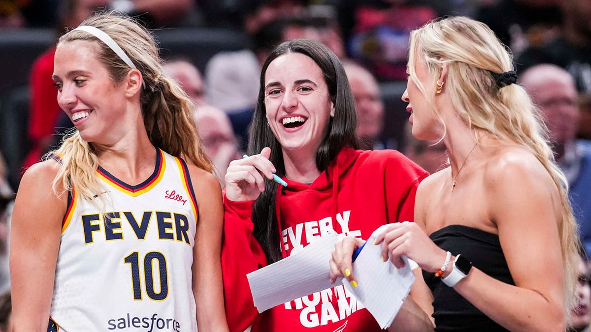 Lexie Hull, Caitlin Clark and Sophie Cunningham laugh on sideline
