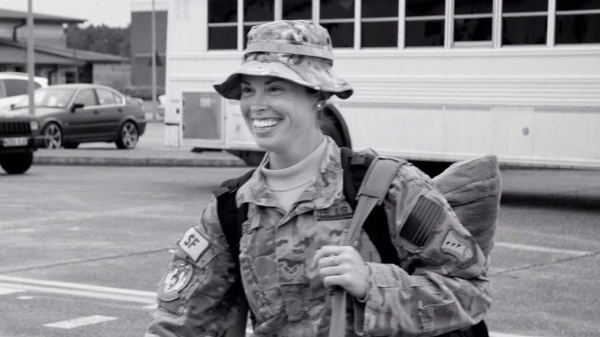 Lindsay Gutierrez in military gear smiling in a black and white photo.