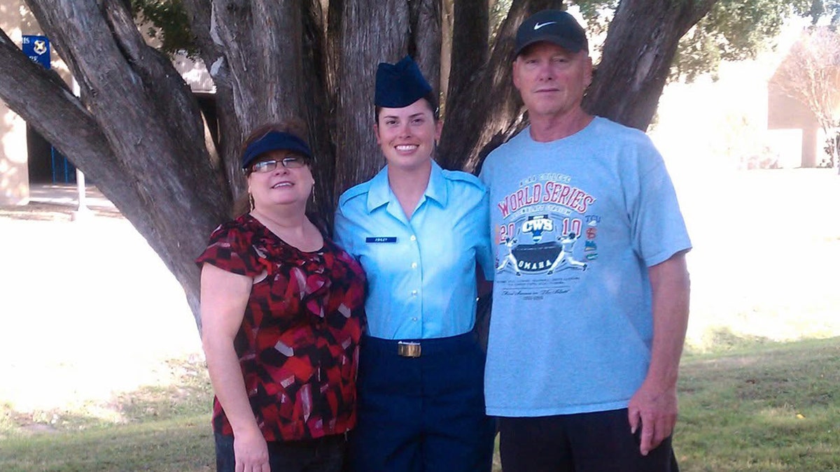 Lindsay Gutierrez in Air Force gear posing next to two older family members.