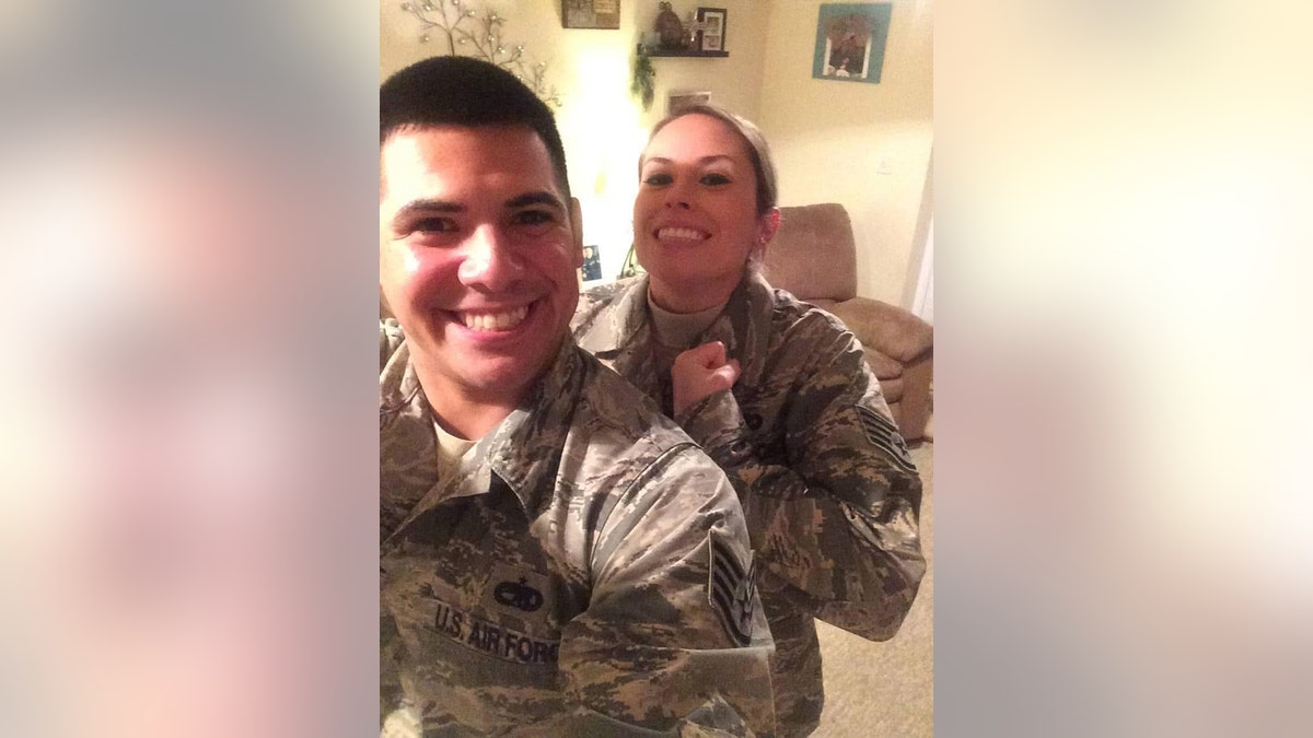 Lindsay Gutierrez in military camo next to a man in a matching uniform.