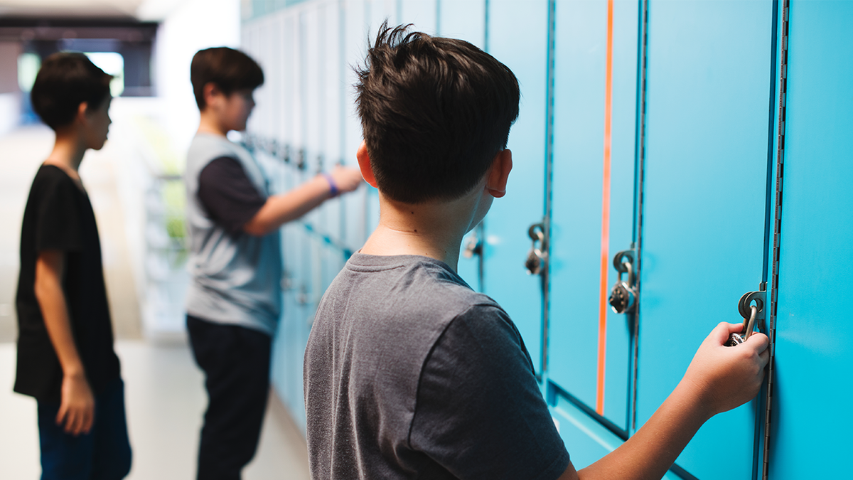 Boys talking to each other in locker room