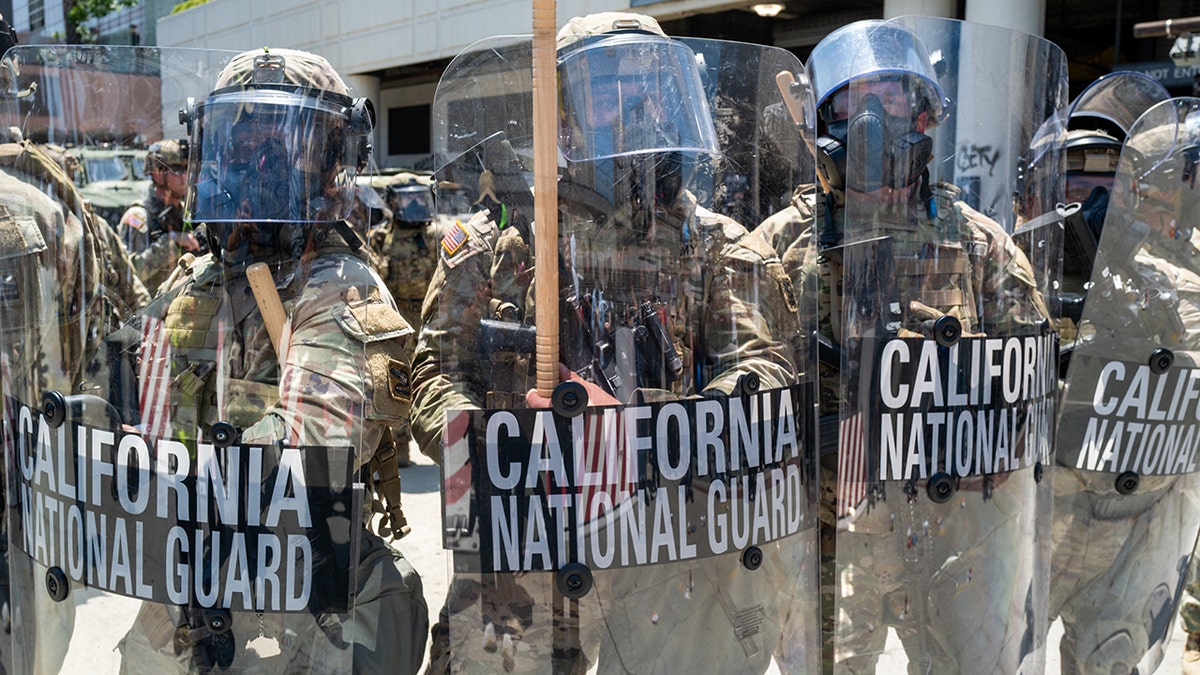 California National Guard in riot gear holding shields