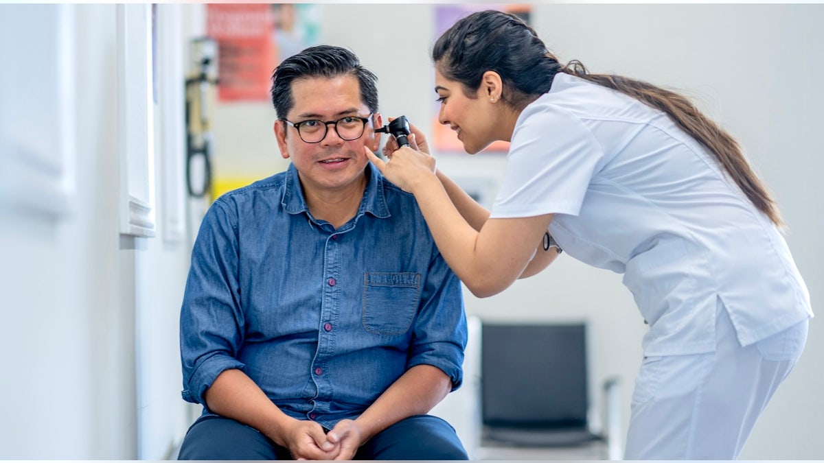 Man at ear doctor