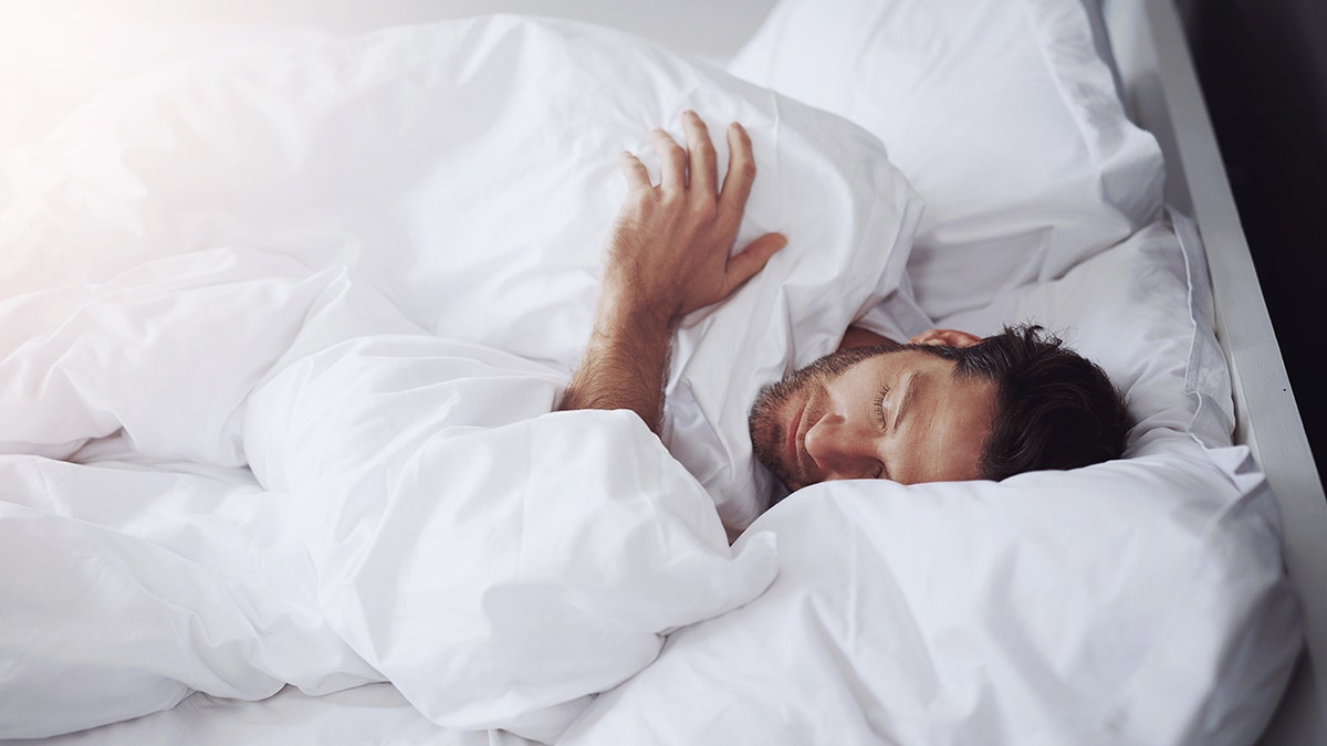 Man asleep in bed