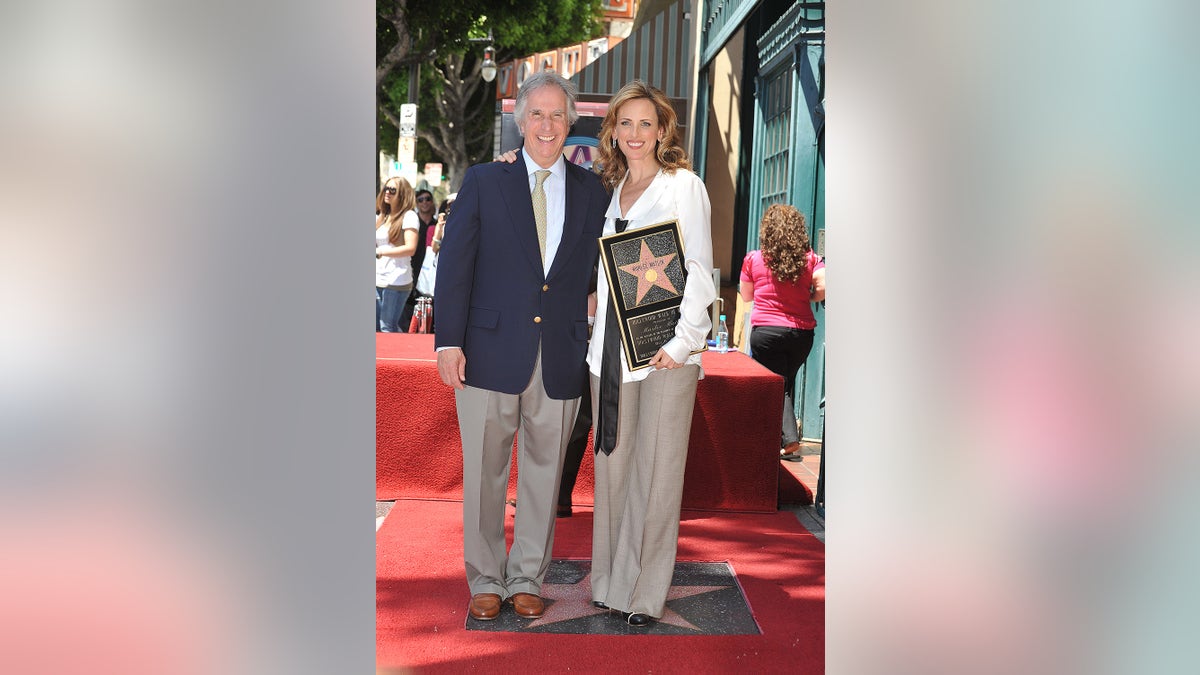 Marlee Matlin and Henry Winkler standing together at the Hollywood Walk of Fame ceremony.