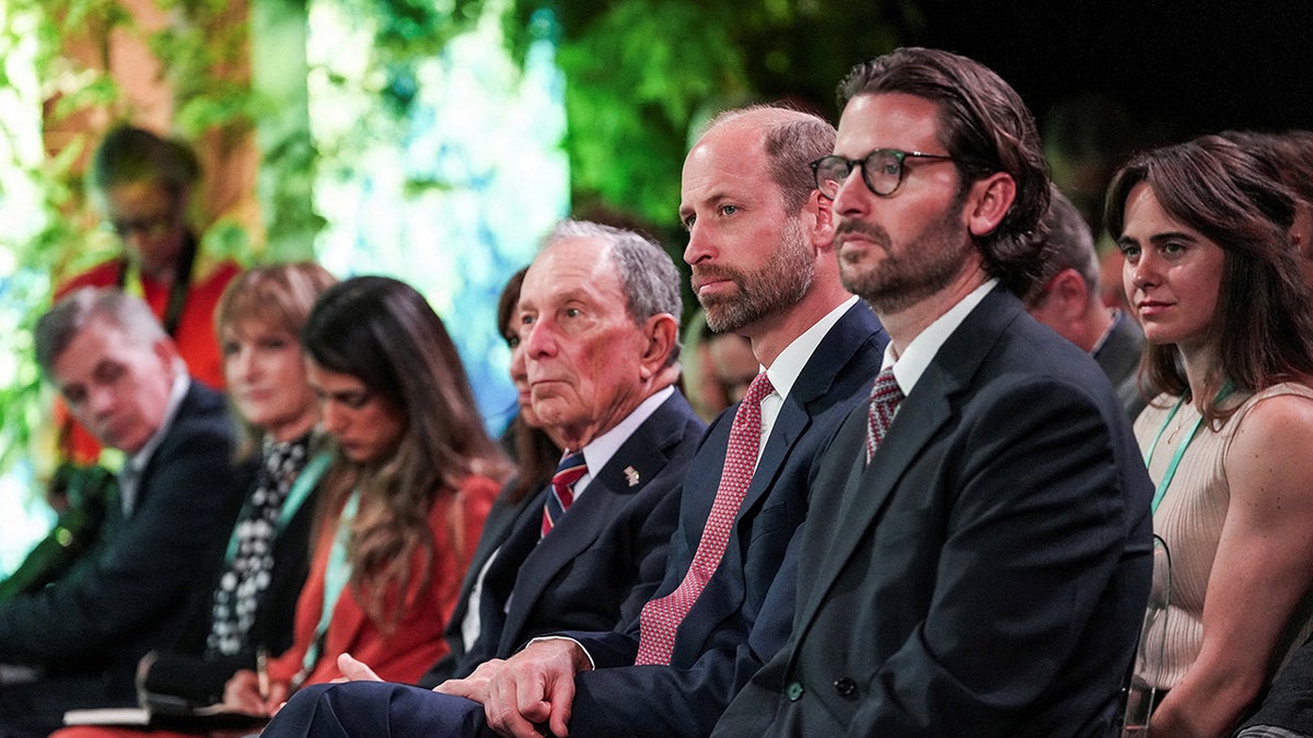 Prince William sitting down betwixt Michael Bloomberg and Jason Knauf.