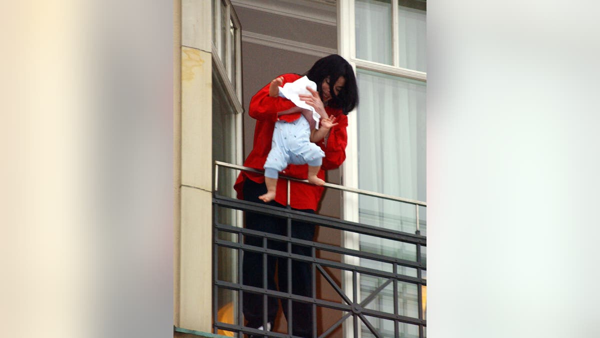 Michael Jackson dangling his infant son Blanket over the balcony