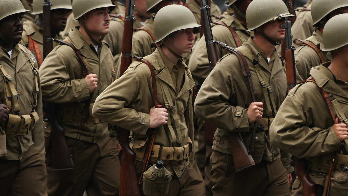 Soldiers dressed in World War II uniforms march in the military parade