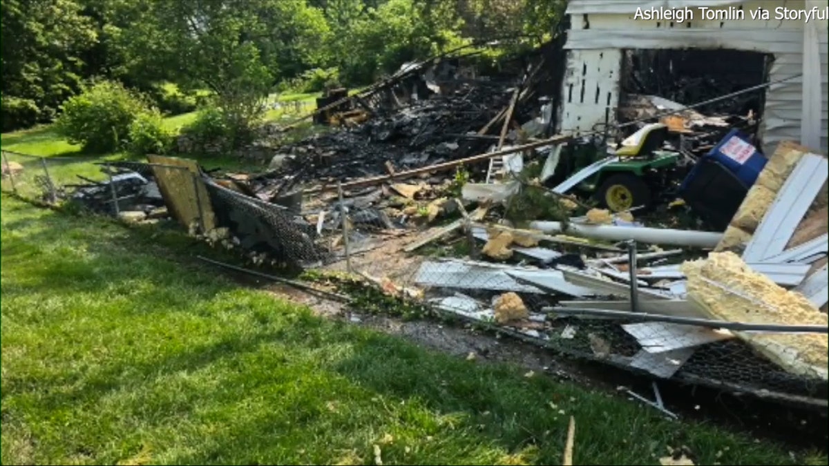 house debris scattered across yard