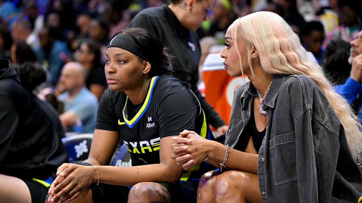 NaLyssa Smith and DiJonai Carrington looks on court