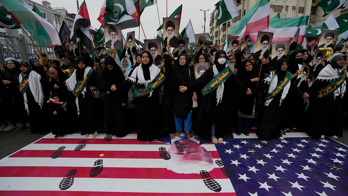Pakistan demonstration with footprints on the American flag