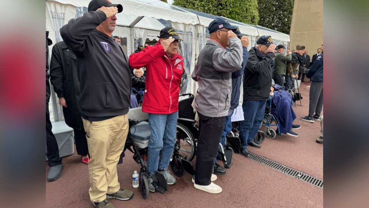 Veterans saluting astatine a D-Day solemnisation parade