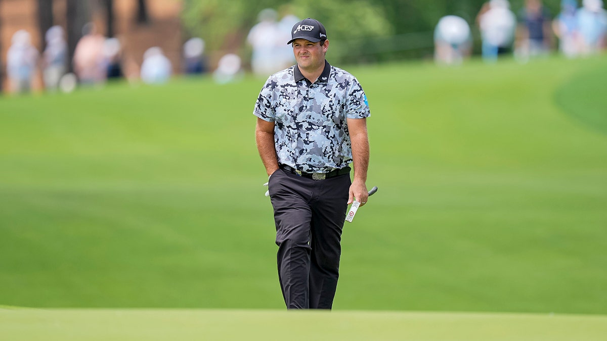 Patrick Reed walks on course