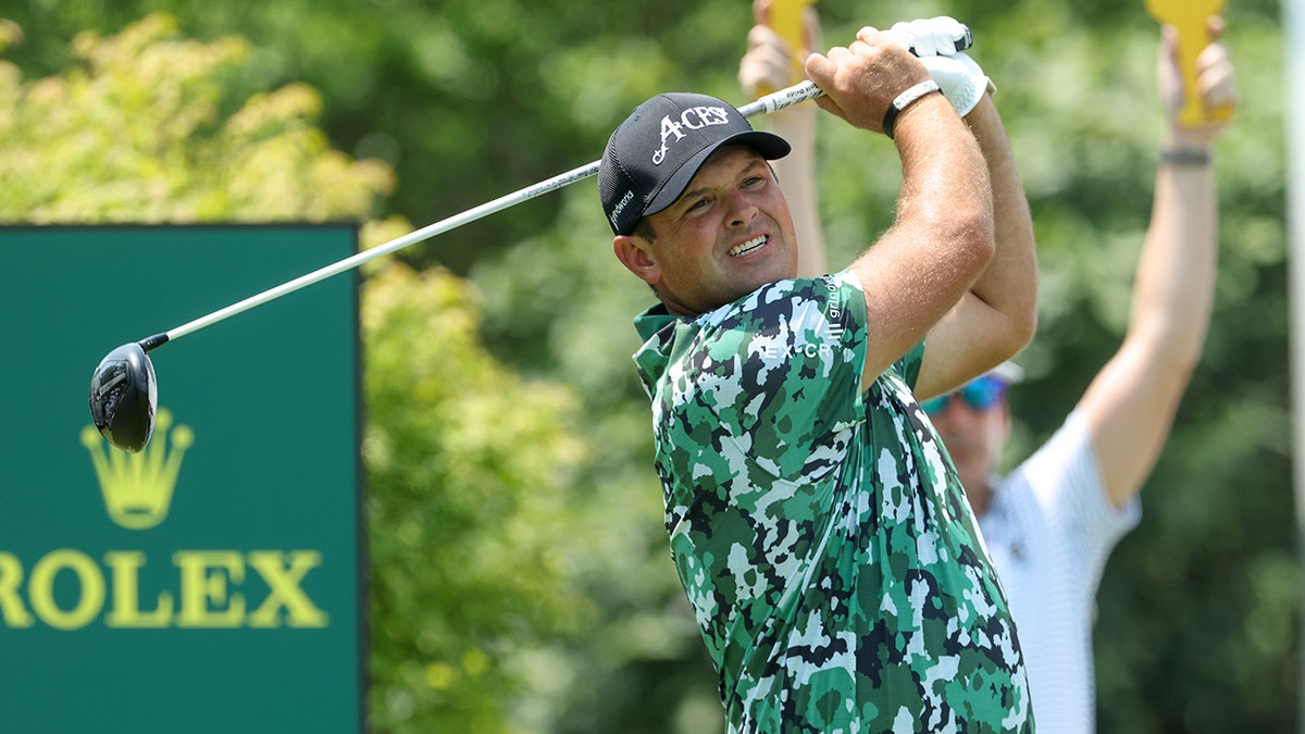 Patrick Reed swings club