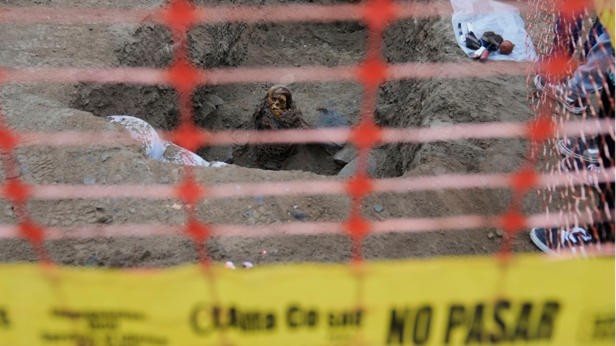 Mummy seen through yellow tape, fencing