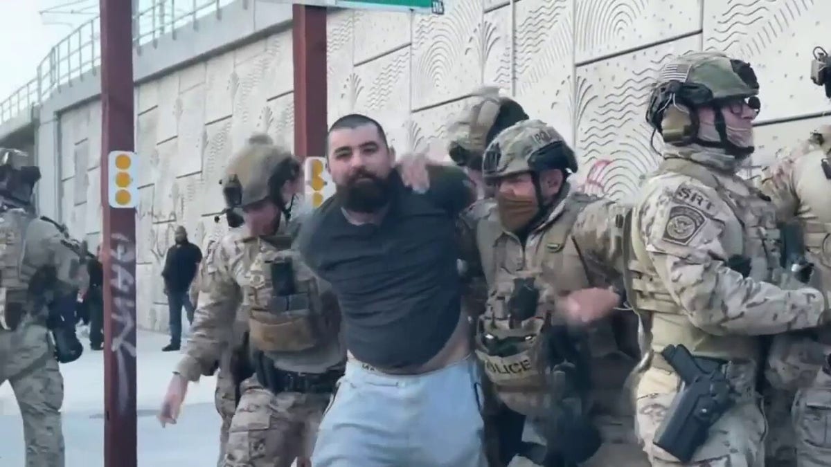 Thomas Guzman was seen in the video being escorted from the protest by authorities.