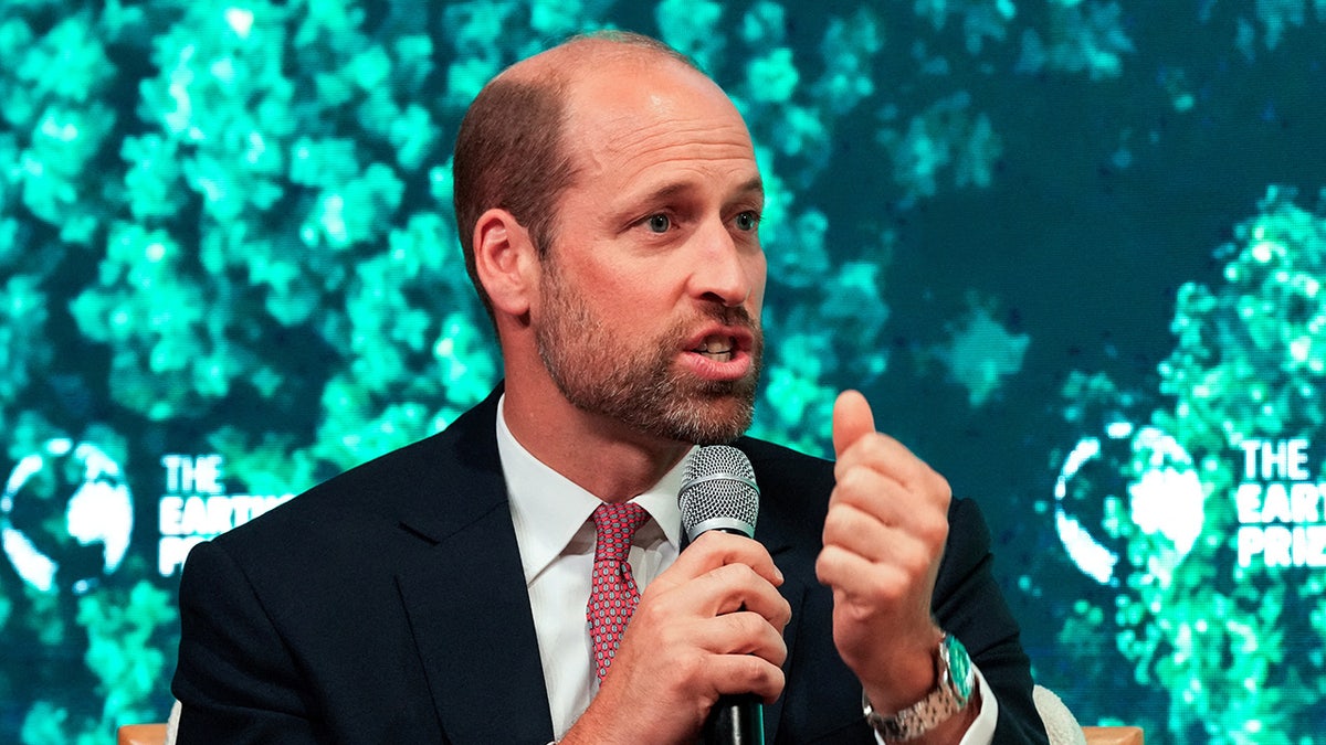 Prince William wearing a acheronian bluish blazer and speaking to a mic.