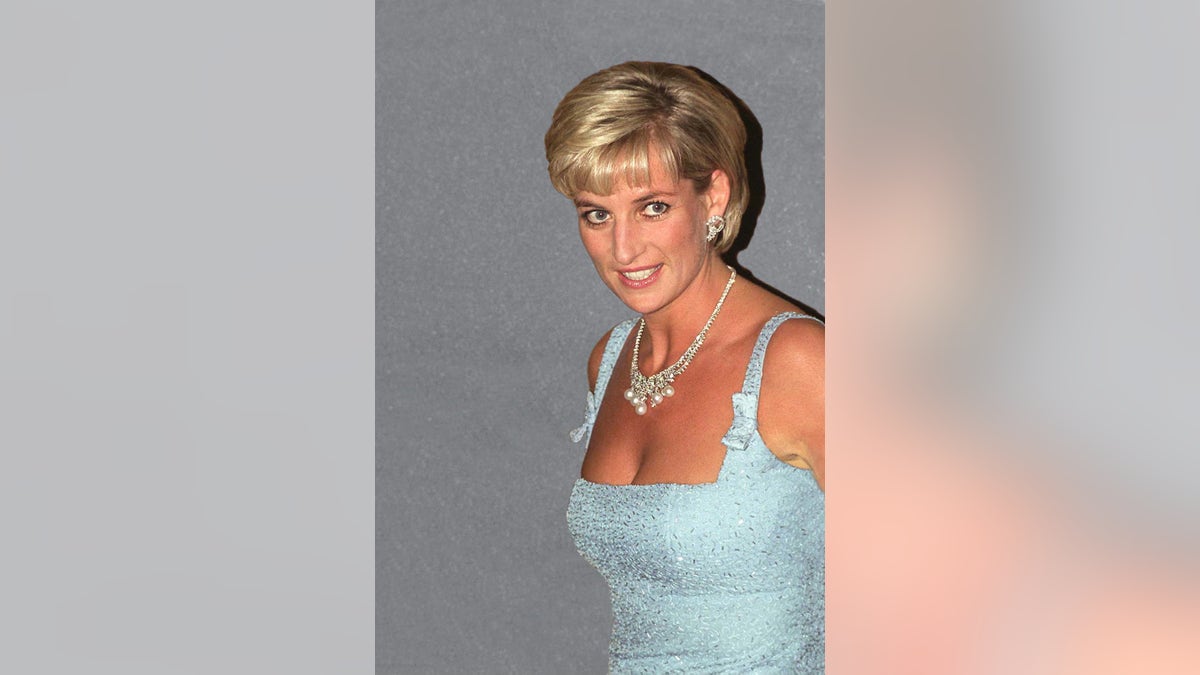 A close-up of Princess Diana wearing an ice blue strappy dress with a diamond and pearl necklace.