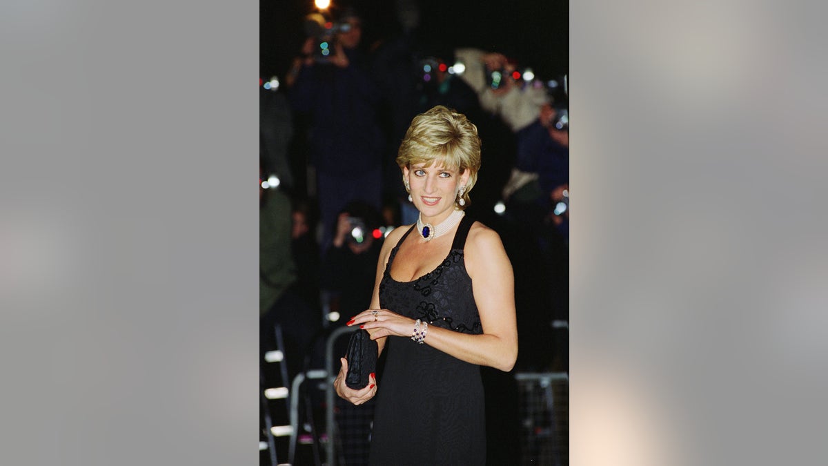 Princess Diana wearing a strappy black dress with a diamond and sapphire choker.