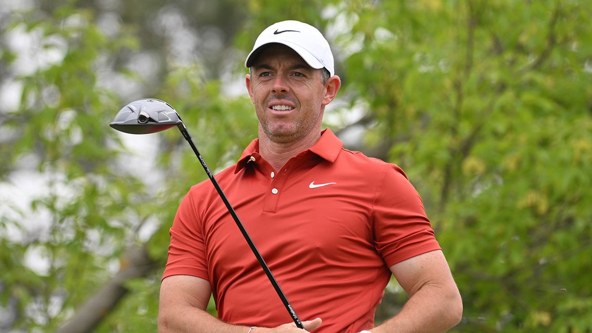 Rory McIlroy reacts to play shot