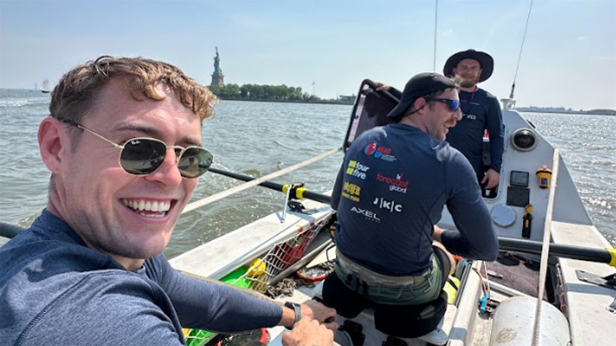 Jack Jarvis smiles in rowboat in NYC harbor