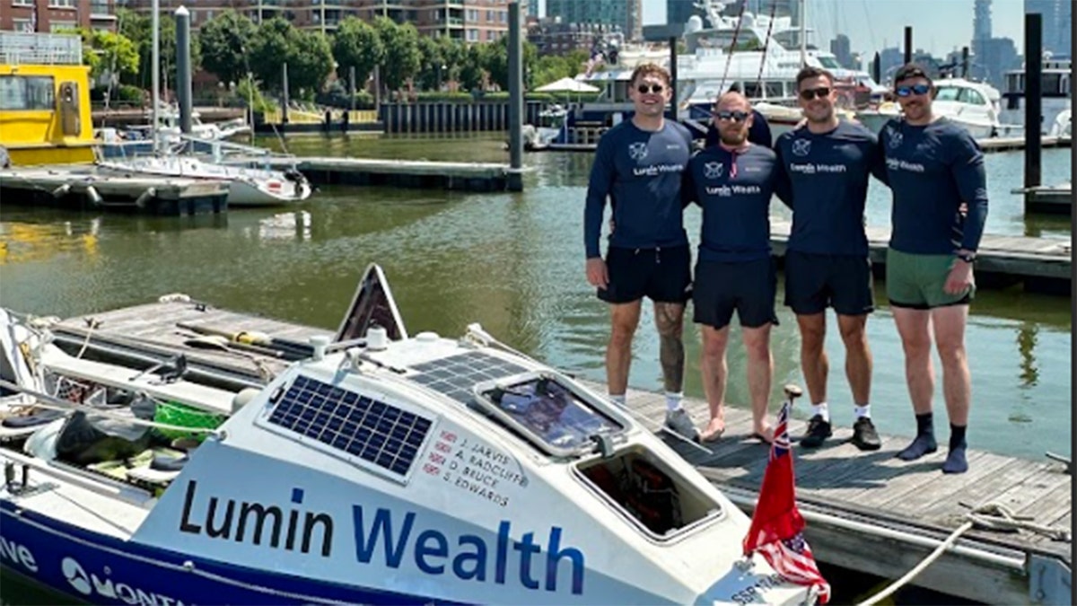 The 4 -man rowing team photographed their boat