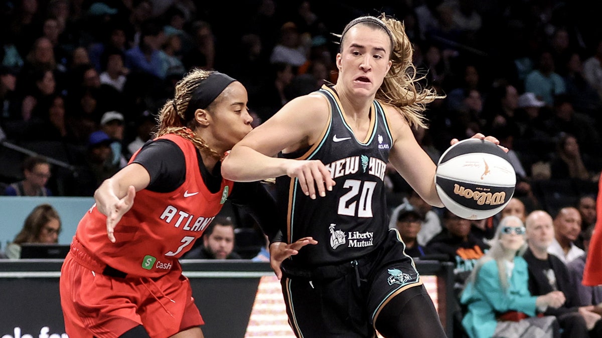 Sabrina Ionescu drives ball