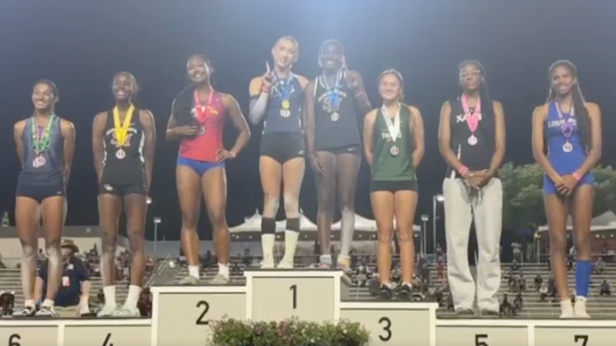 AB Hernandez shares the first-place spot on the triple jump podium at the California track and field state championship with a female competitor.
