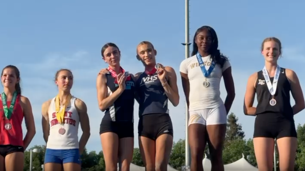 AB Hernandez shares the long jump second-place spot on the medal podium with a female competitor at the California state track and field championship.