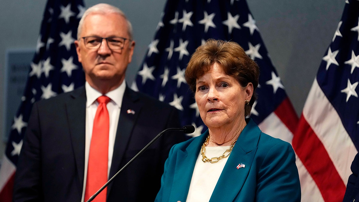 Shaheen speaks with another senator in Ottawa